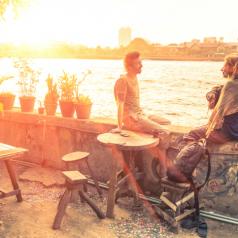couple sits on patio talking at sunset
