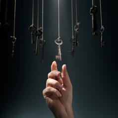 Hand choosing a hanging key