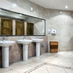 View of three sinks inside a fancy public bathroom