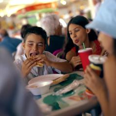 Kids eating unhealthy food at restaurant