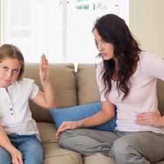 Preteen makes "talk to the hand" gesture to mother