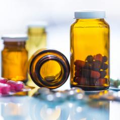Medicines in blister packaging and brown glass bottles
