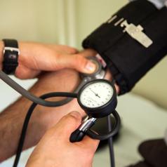 Doctor measuring patient blood pressure