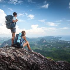 Hiker couple standing on top of the mountain