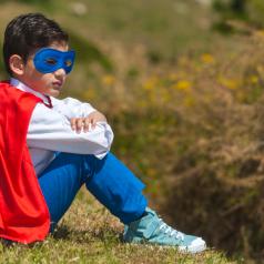Kid sitting in superhero costume