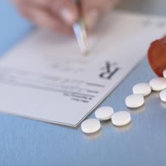Pharmacist writing on prescription paper