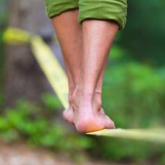 feet on slack line in woods