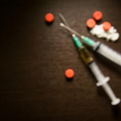 Slightly out-of-focus hypodermic needles with heroin