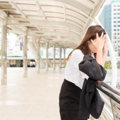 Stressed woman leaning against railing