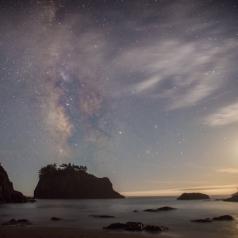 Milky Way and moon at dawn over California beach
