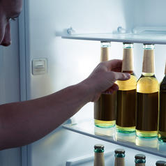 Man reaching in fridge for a beer