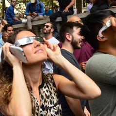 People watching 2017 eclipse on New York street