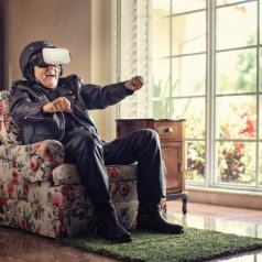 Elderly man uses VR technology to race from the comfort of his chair.