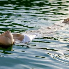 Woman floating on her back in water