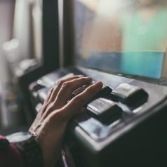 Close-up of hand resting on slot machine