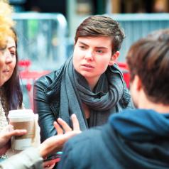 Androgynous college student has coffee with friends
