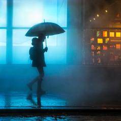 A person walks home alone in the rain
