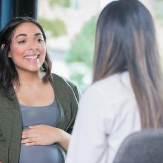 Pregnant woman talking with her care provider