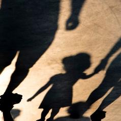Shadows of parents holding child