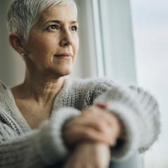 Mature woman gazing out the window