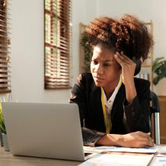 Woman on computer frustrated with insurance